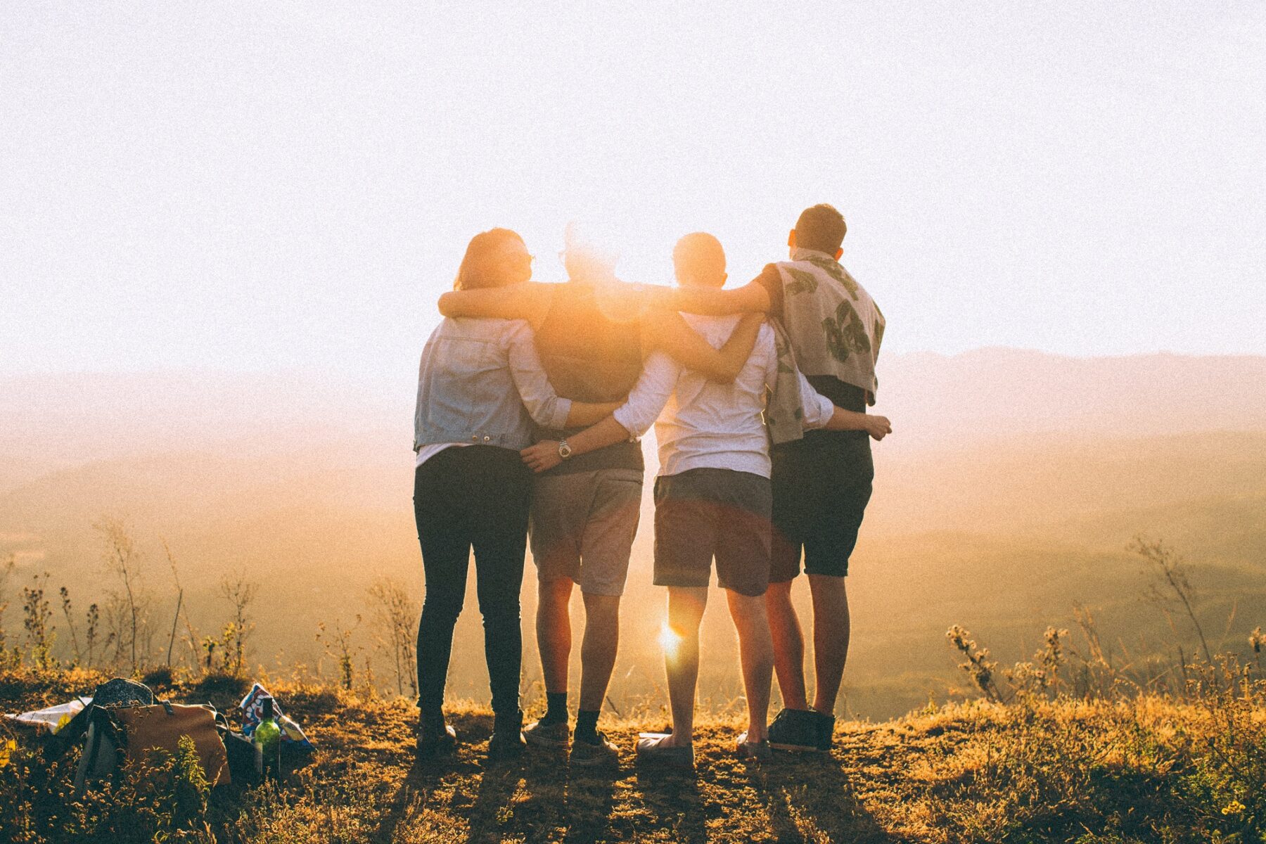 friend hugging looking at a sunset