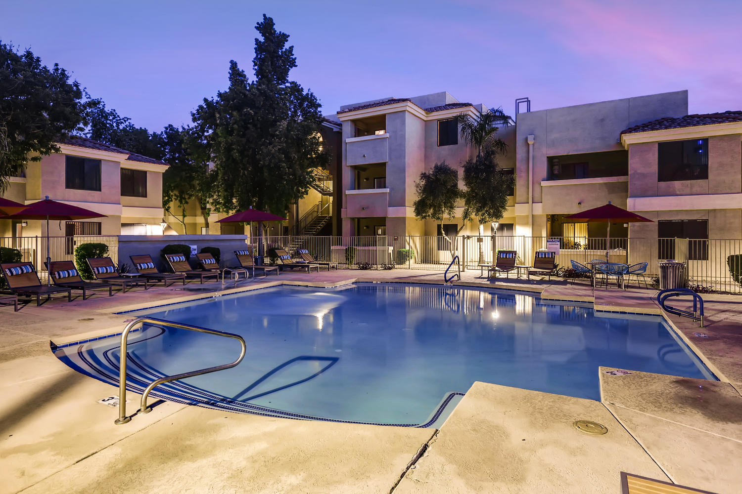 Pool area with deck seating at Espiral luxury apartments in Gilbert, AZ