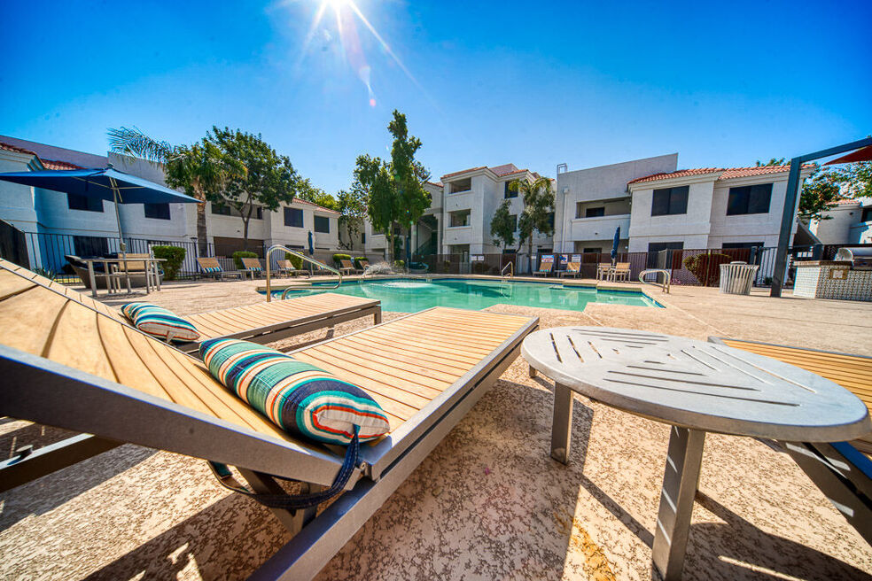 view of pool from lounge chairs inside the fence area