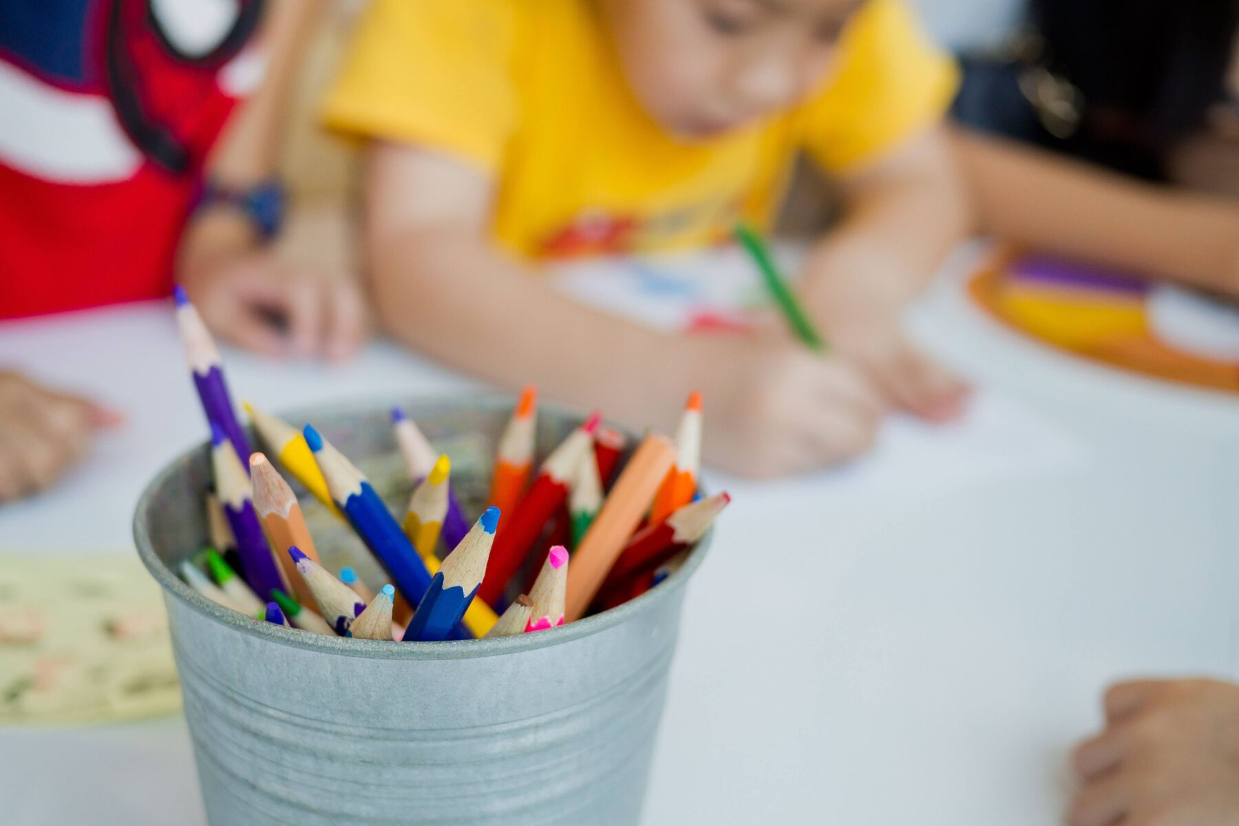 kids using color pencils to draw