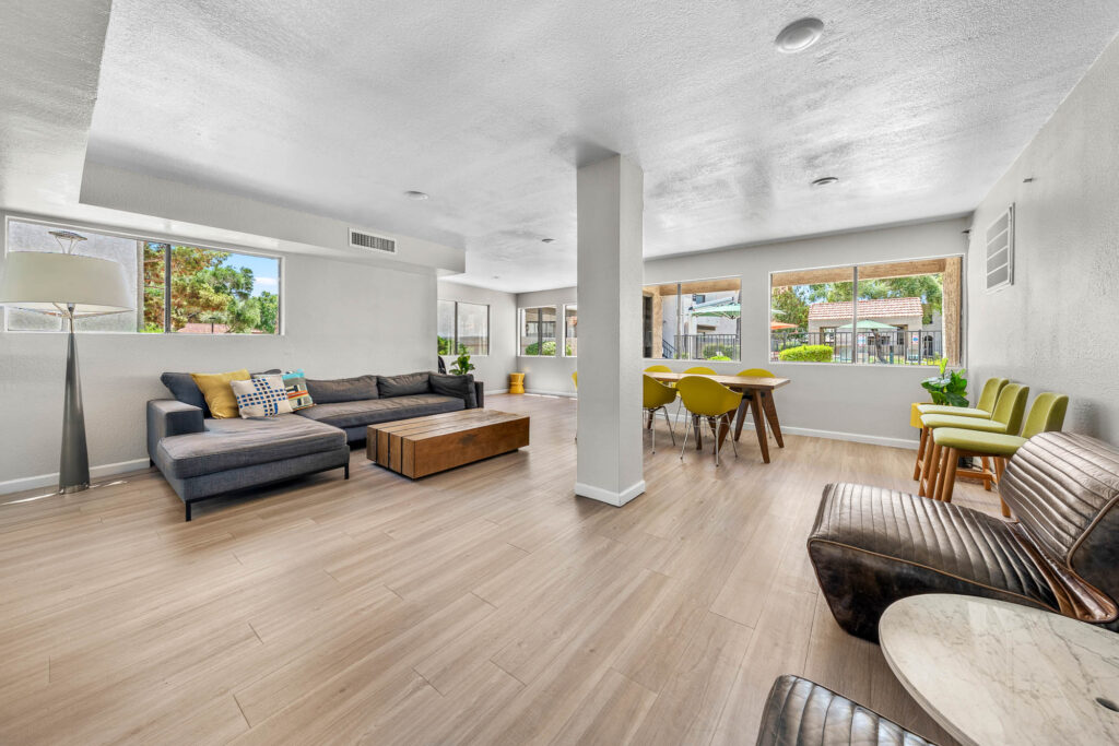 indoor lounge space with various armchair and sofa seating, including a dining table with chairs and plenty of natural lighting