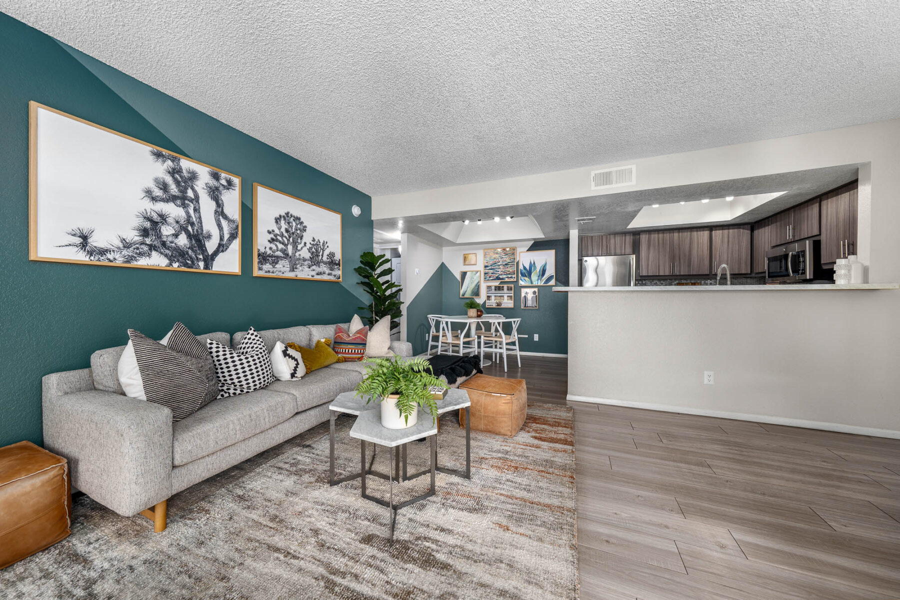 living room and dining room space with accent wall and various wall decor items
