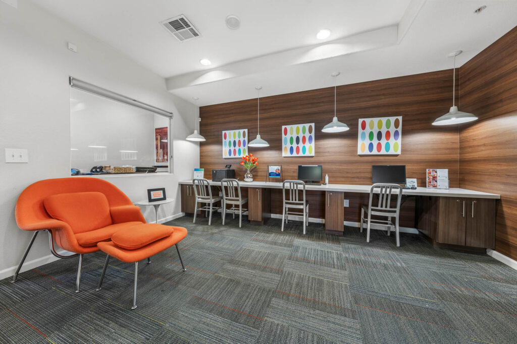 Computer room with carpet flooring, designer lighting, computers, and wall decor